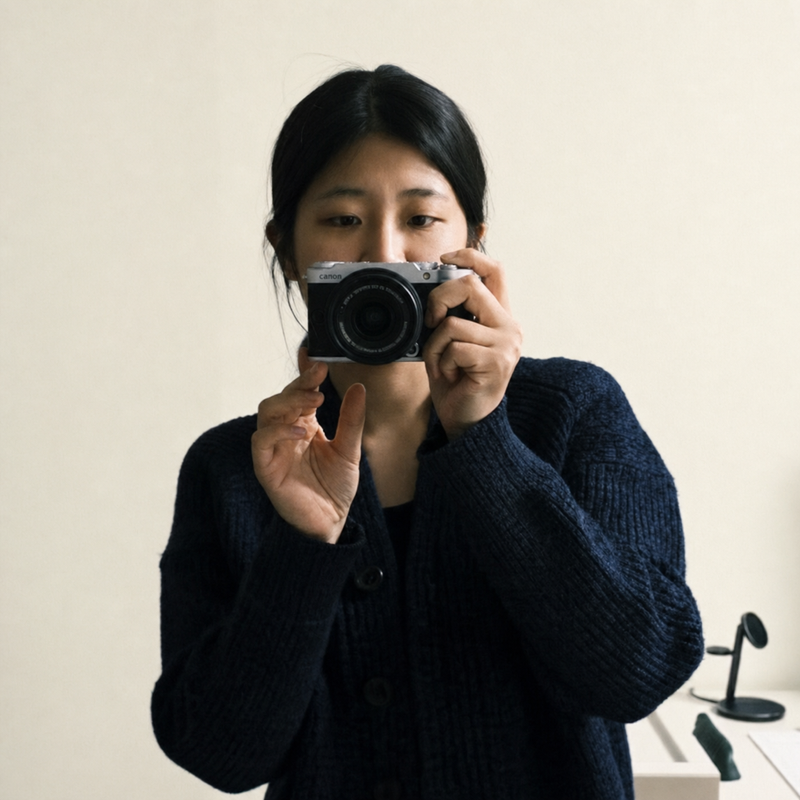 Yeji Han taking a mirror photograph with a camera